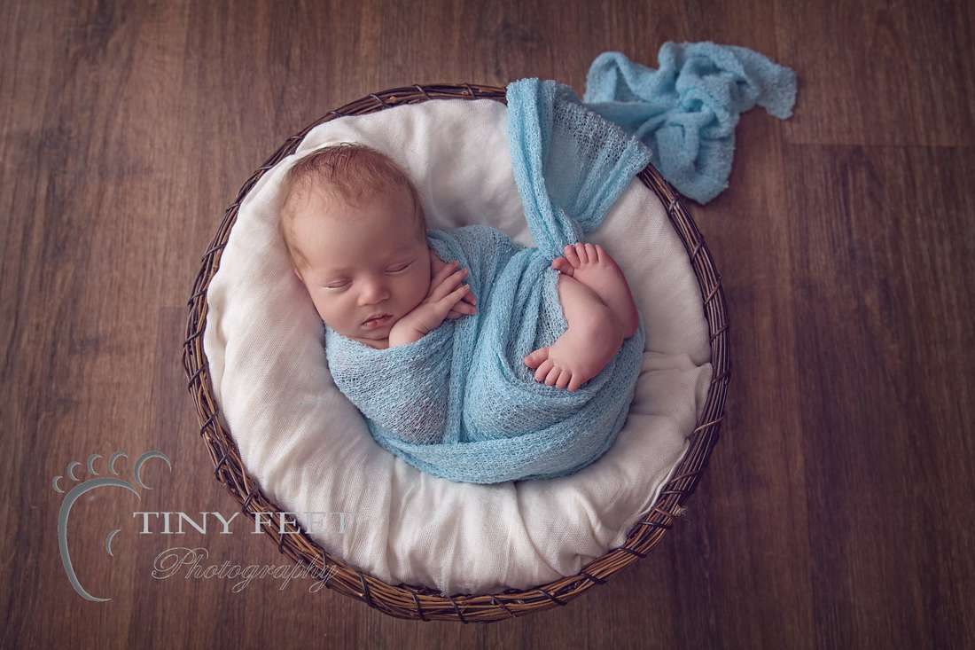 Tiny Feet Photography, newborn baby boy wrapped in blue wrap in a bowl