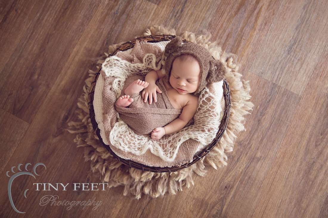 Tiny Feet Photography Newborn boy posed in basket
