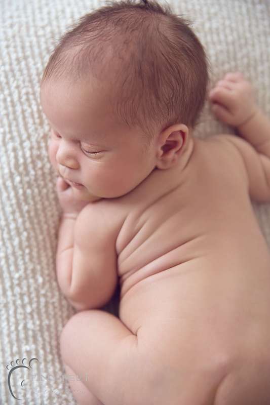 Tiny Feet Photography Newborn boy on cream blanket in bum up pose