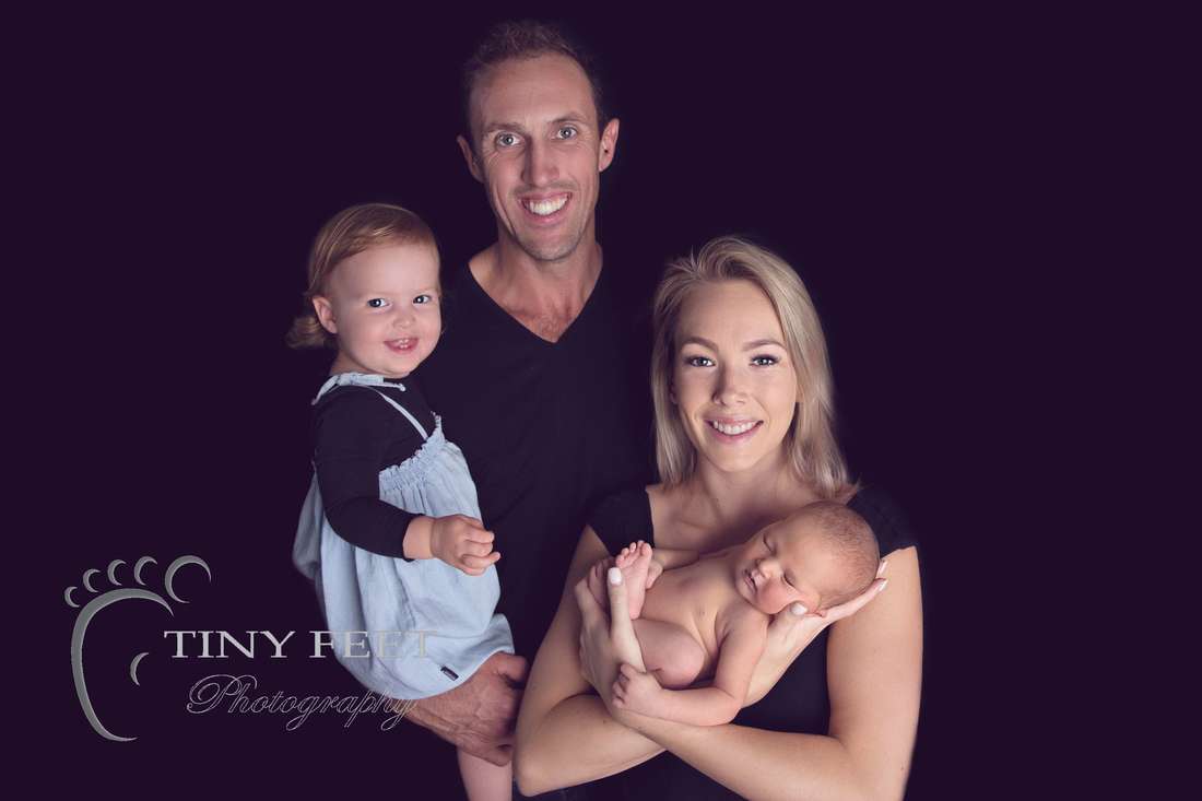 Tiny Feet Photography Newborn baby girl family posing with sibling and mum and dad