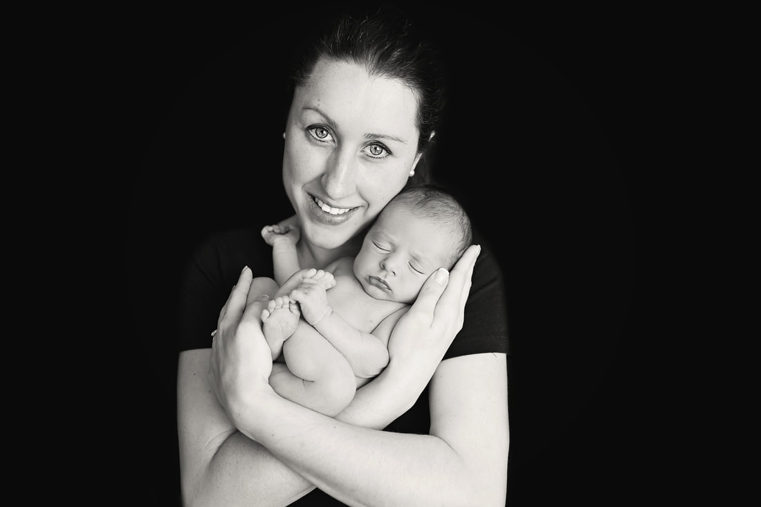 Tiny Feet Photography newborn posing with mum on black backdrop