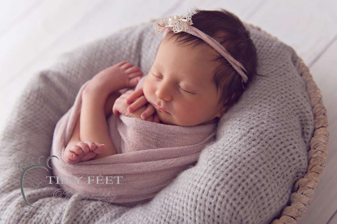 Tiny Feet Photography, newborn baby girl in pink wrap in a bowl back lit