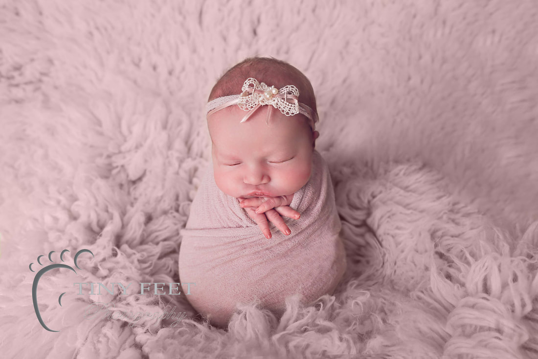Tiny Feet Photography baby girl posed in pink wrap on flokati in potato sack