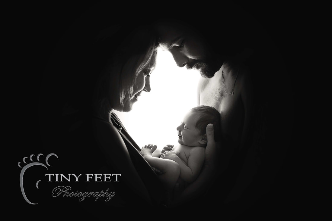 Tiny Feet Photography, newborn baby posed with mum and dad backlit black and white 