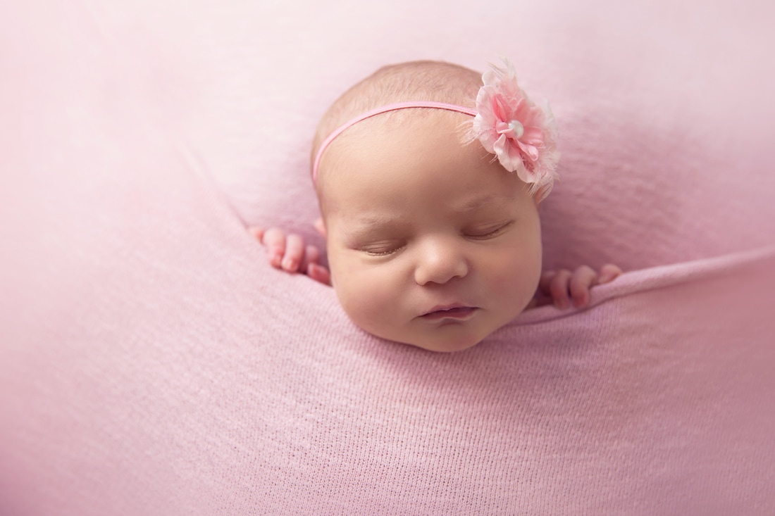 Tiny Feet Photography Newborn baby girl tucked in pink blanket
