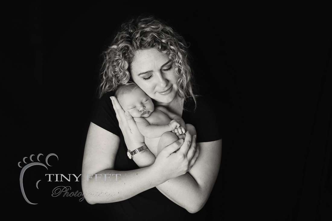 Tiny Feet Photography black and white image of newborn with parents