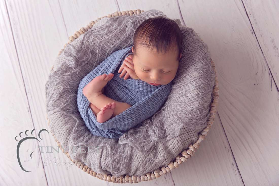 Tiny Feet Photography Newborn baby boy posed in blue wrap in bowl