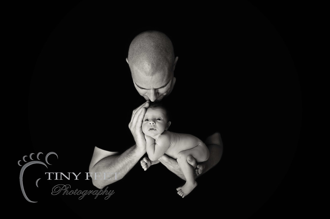 Tiny Feet Photography baby boy posed in dads hands