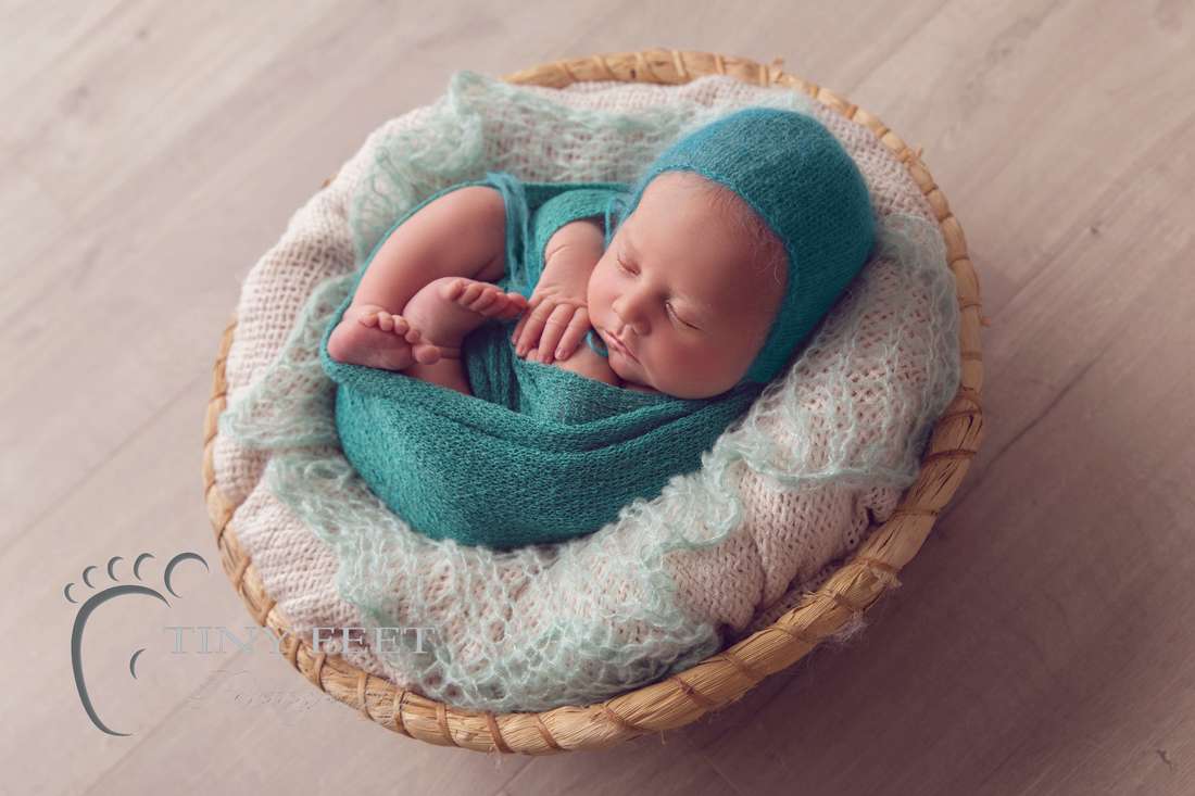 Tiny Feet Photography newborn baby boy in green wrap posed in bowl