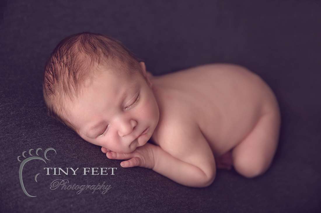 Tiny Feet Photography baby boy posed on grey blanket on tummy