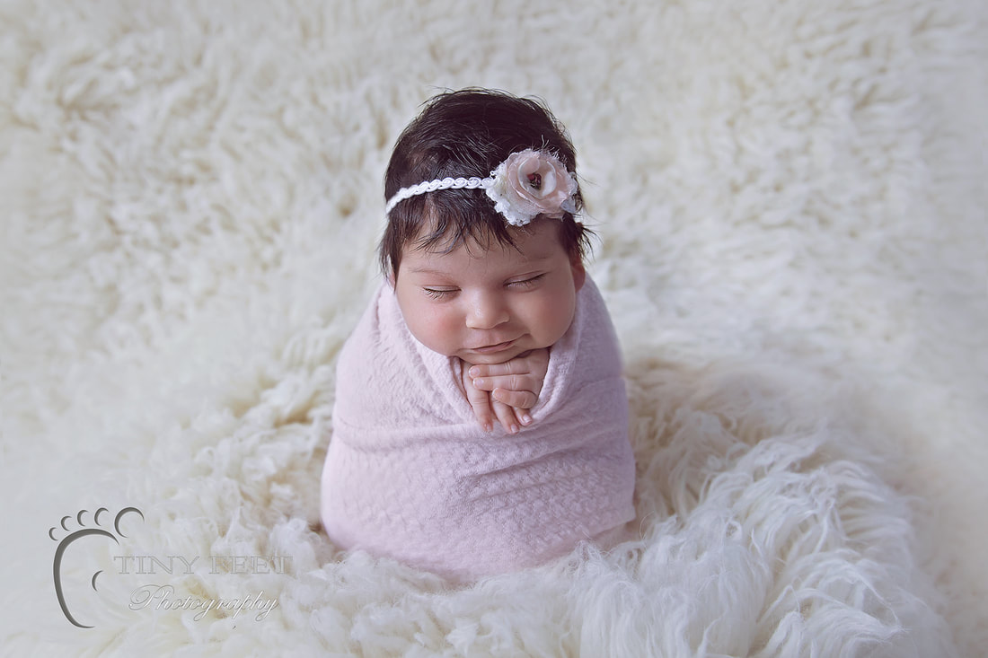 Tiny Feet Photography newborn baby girl in potato sack on white flokati 