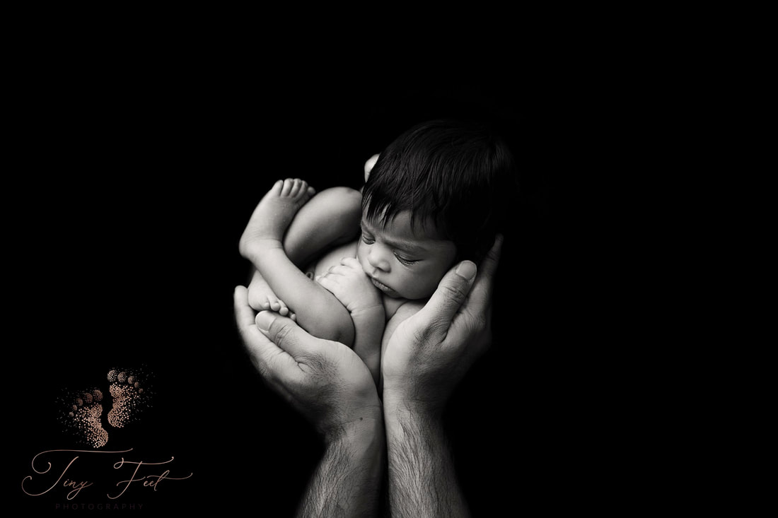 Tiny Feet Photography Newborn girl black and white posed in daddy's hands