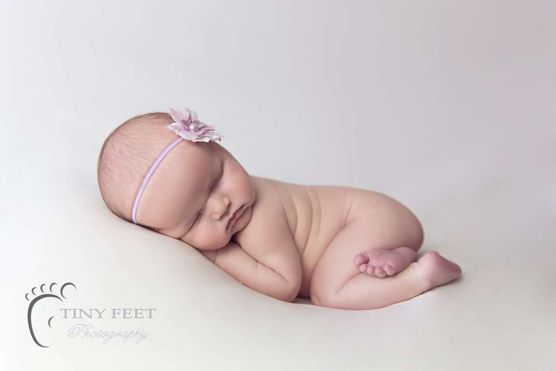 Newborn photography posing on a beanbag