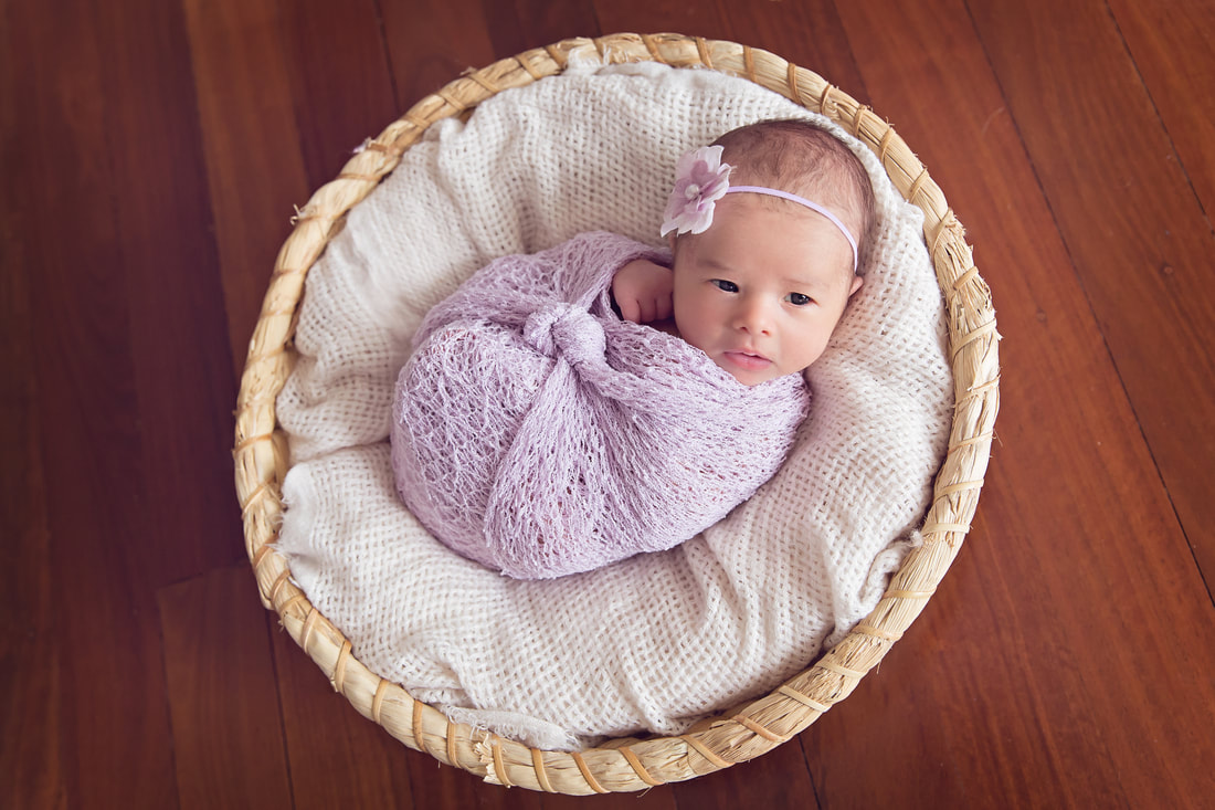 Tiny Feet Photography Newborn baby girl awake posed in basket