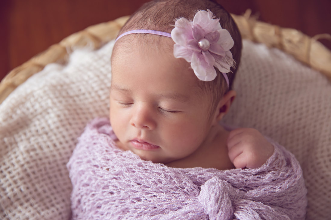 Tiny Feet Photography Newborn baby girl posed in basket
