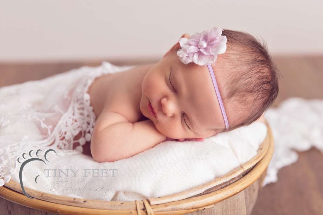 Tiny Feet Photography baby girl posed in coconut bowl on tummy