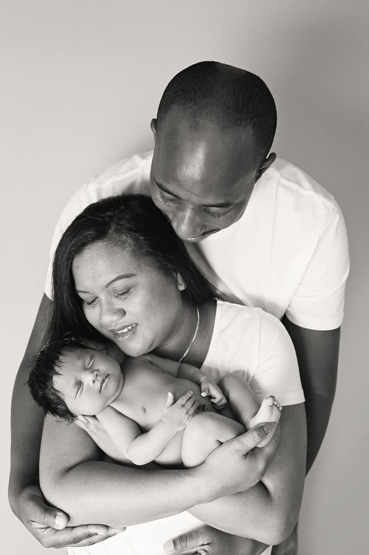 Black and White baby girl posed with mum and dad