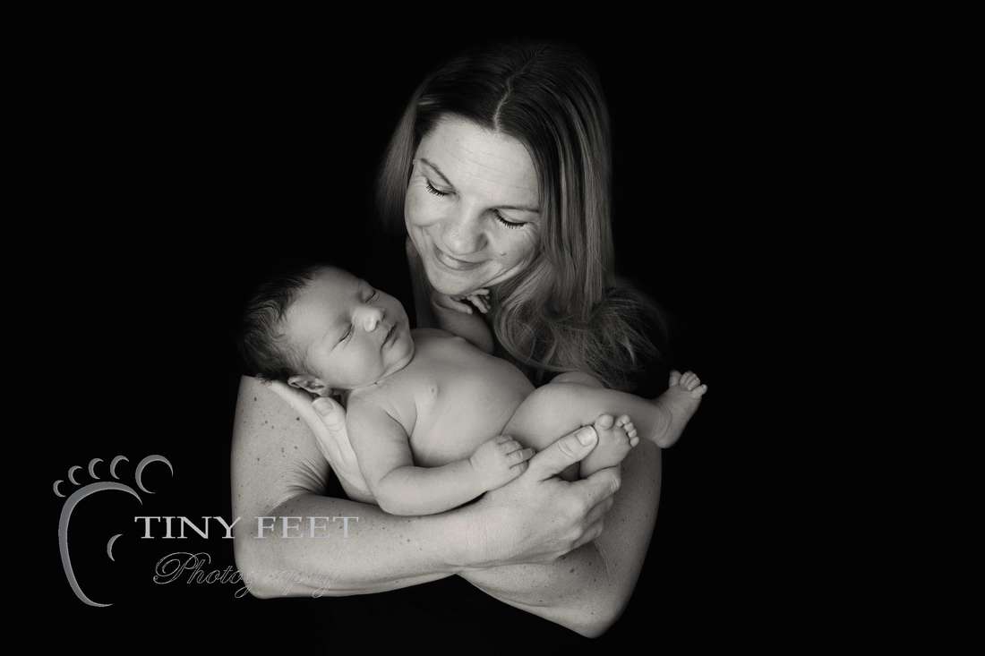 Tiny Feet Photography black and white image of newborn baby boy posed with mum