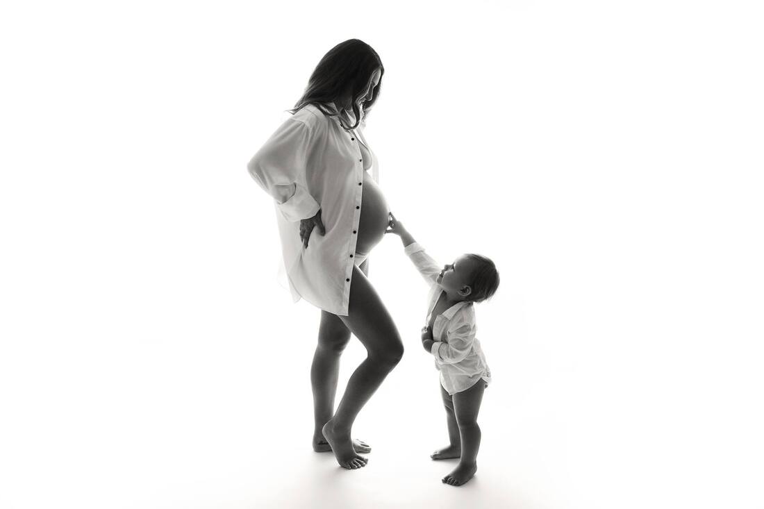 pregnant mother and son in studio maternity photo shoot