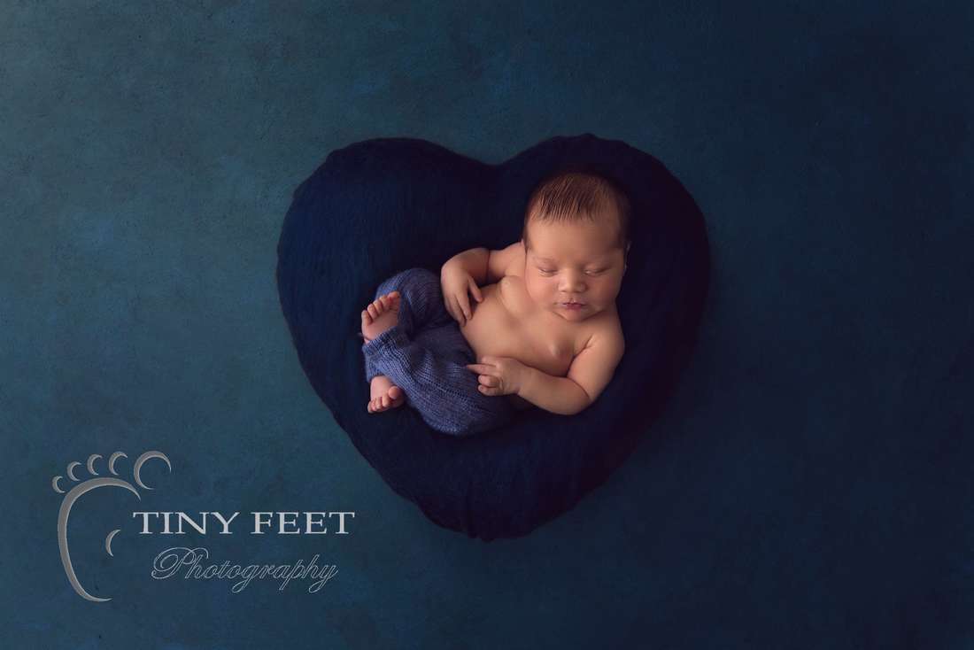 Tiny Feet Photography baby boy posed on blue digital backdrop heart