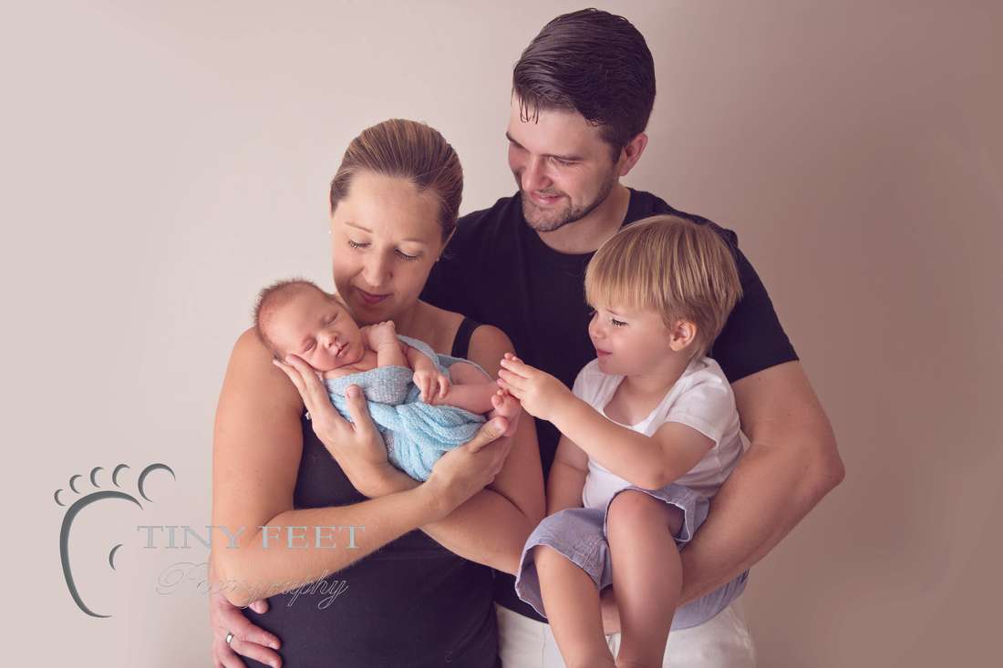 Tiny Feet Photography Family posing with 2 year old sibling
