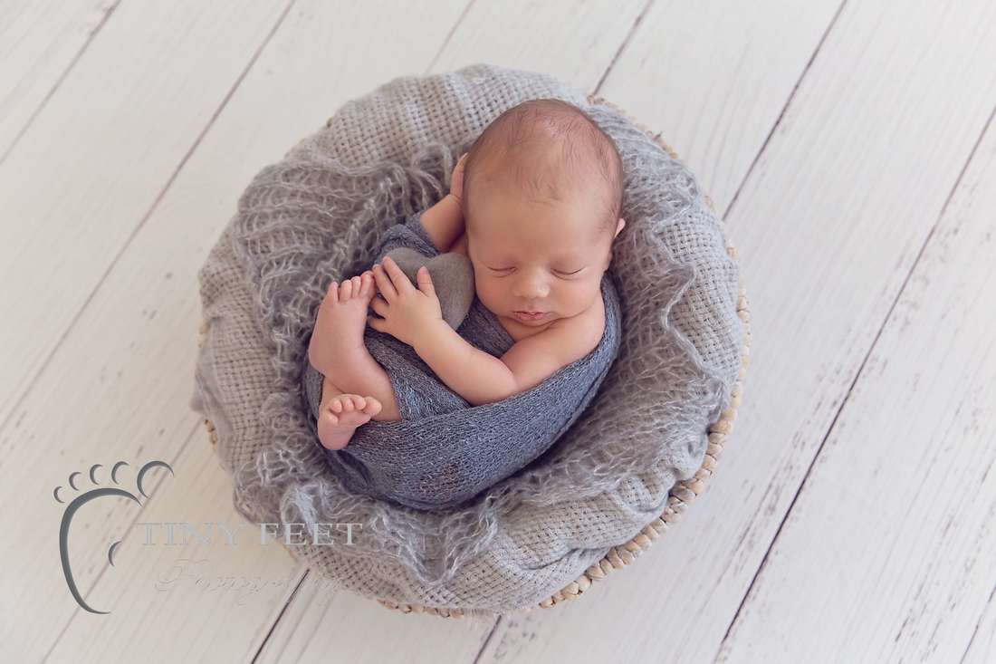 Tiny Feet Photography Newborn baby boy posed in grey bowl with love heart