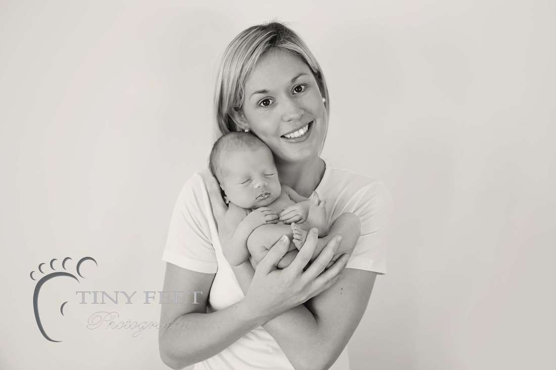 Tiny Feet Photography Newborn baby boy Black and white posed shot with parents 