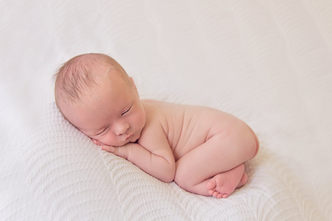 Tiny Feet Photography Baby boy posed on white beanbag