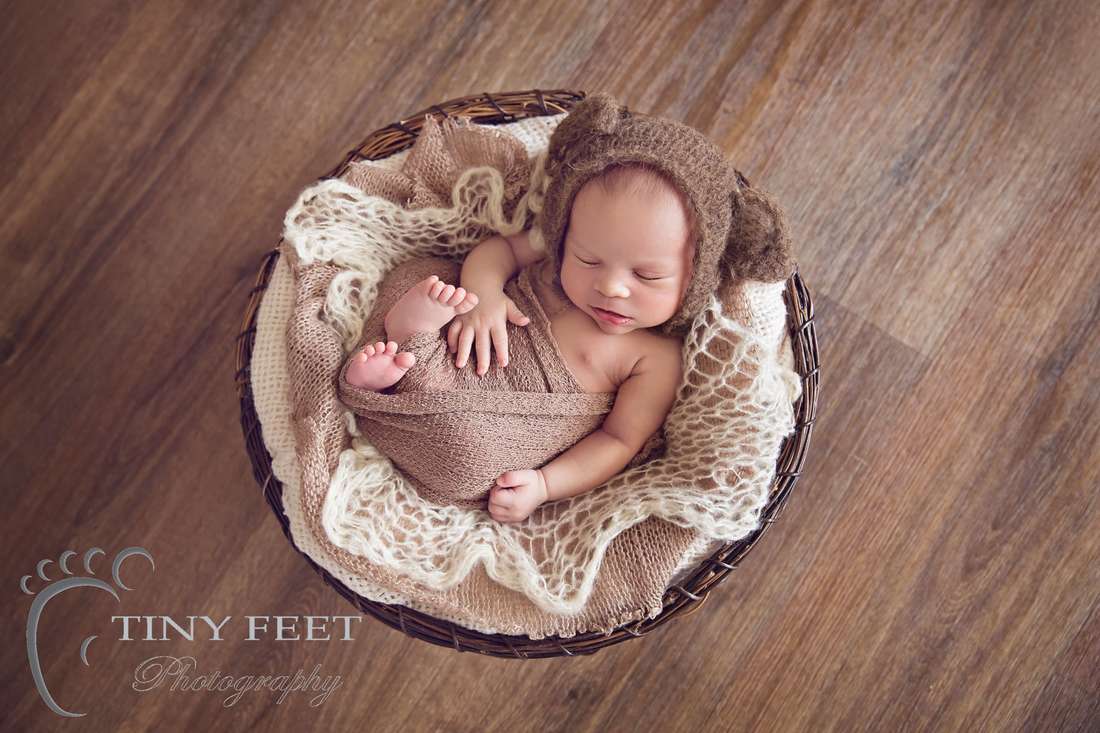 Tiny Feet Photography Newborn boy posed in basket