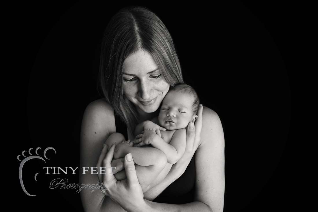 Tiny Feet Photography, newborn baby boy posed in mums arms in black and white