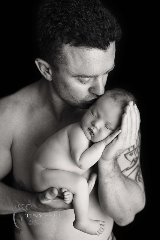 Tiny Feet Photography, newborn baby boy posed with dad in black and white