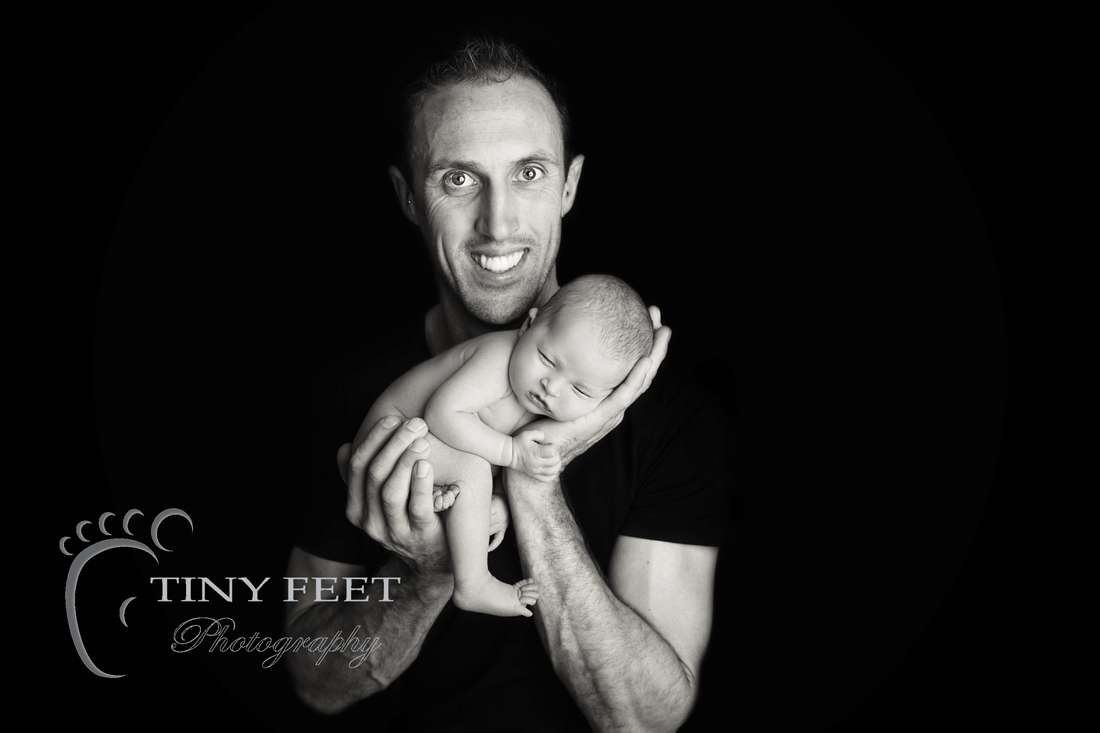 Tiny Feet Photography black and white image newborn baby posed with dad