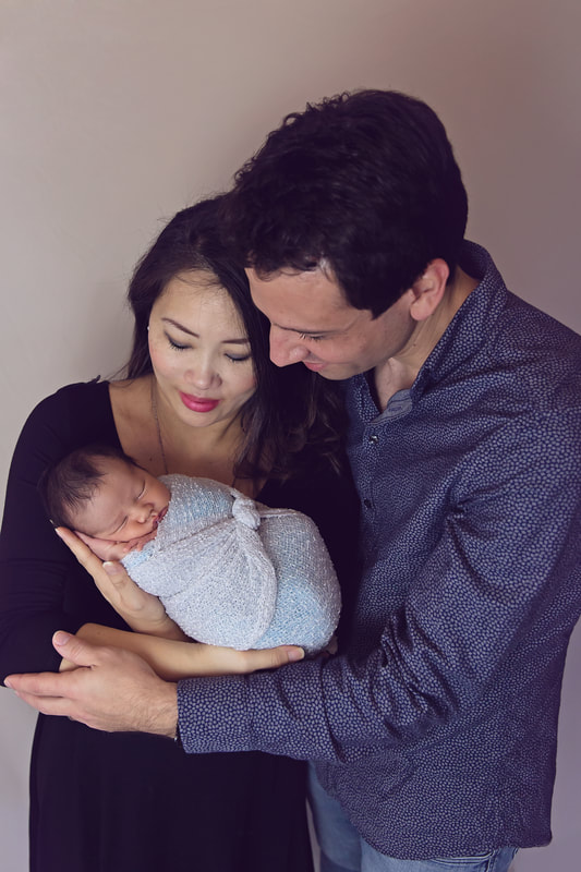 Tiny Feet Photography family posing with newborn