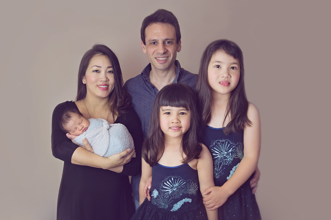 Tiny Feet Photography family posing with newborns