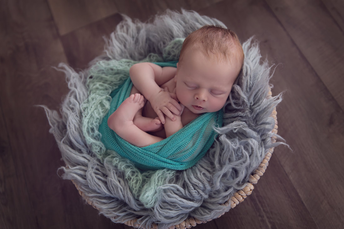 Tiny Feet Photography Newborn baby in posing bowl with green and grey