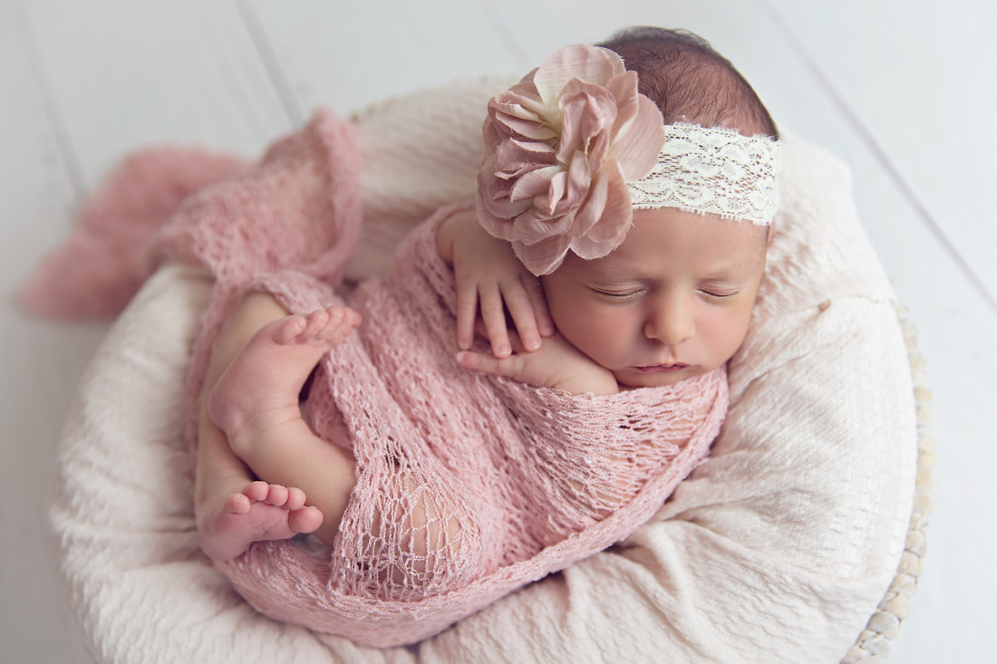 Tiny Feet Photography Newborn baby girl in pink wrap posed in basket
