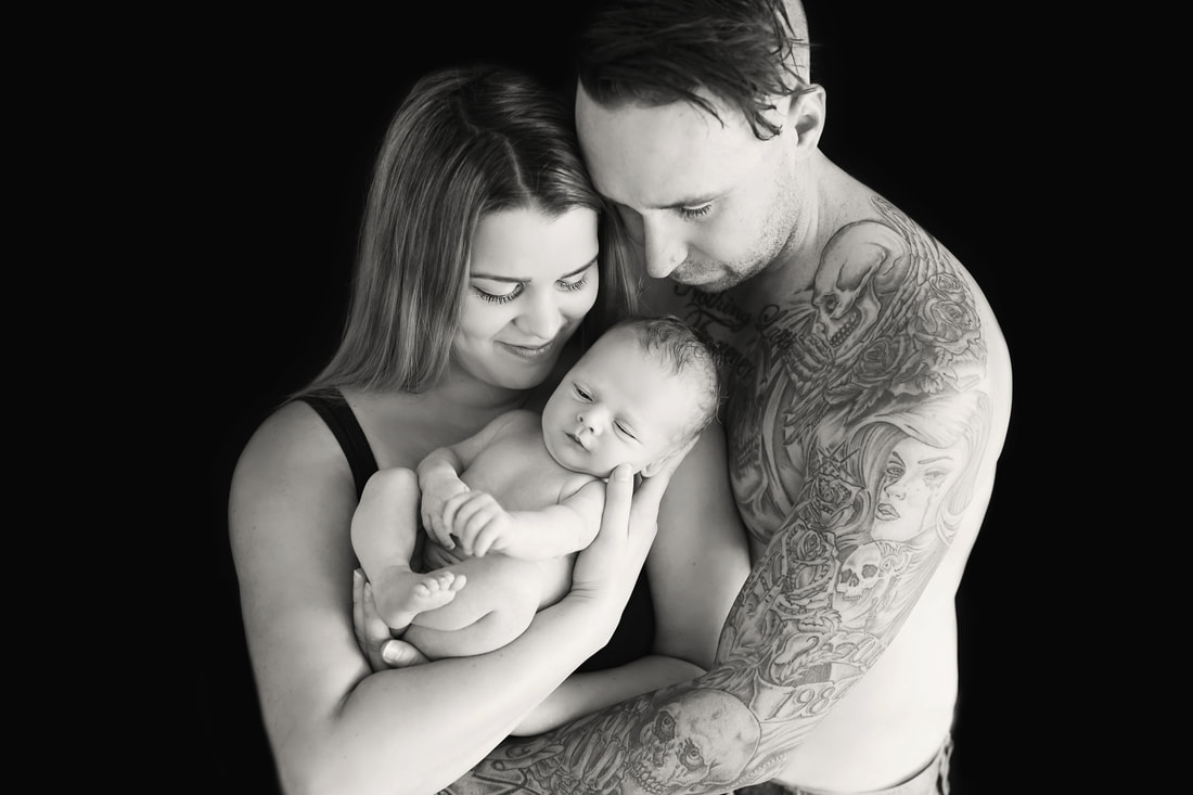 Tiny Feet Photography Black and white family posing image with newborn baby