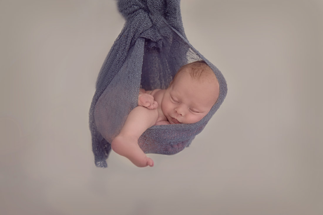 Tiny Feet Photography newborn baby hanging in wrap!