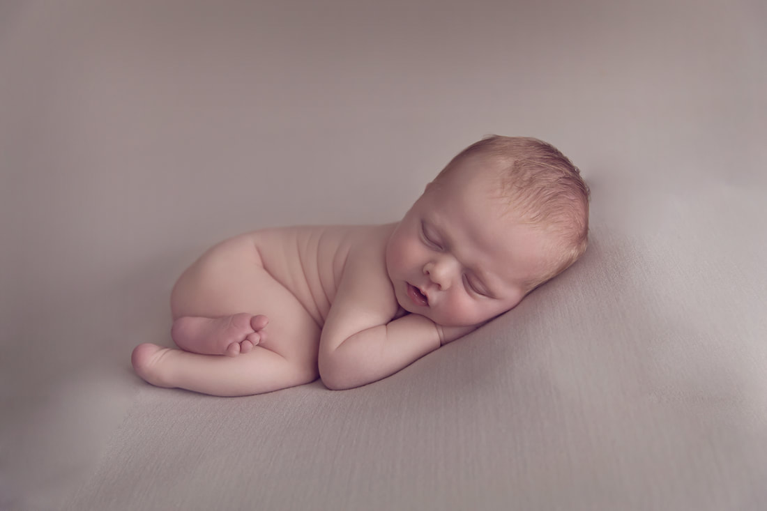 Tiny Feet Photography Newborn posing on beanbag