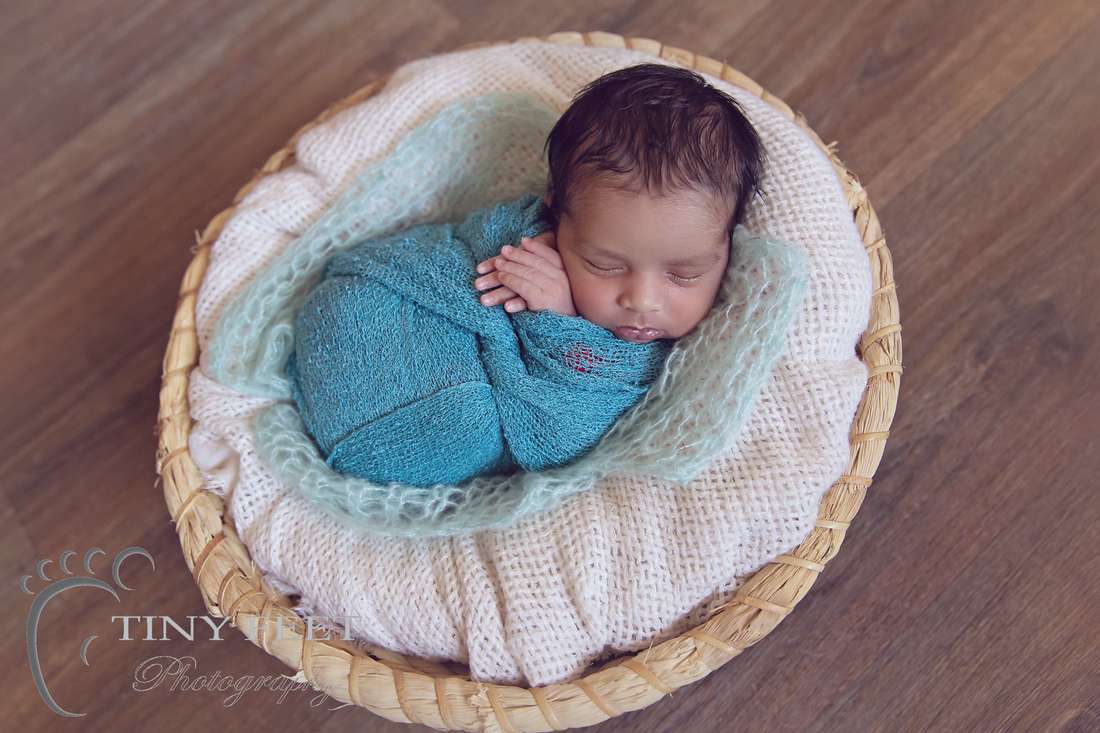 Tiny Feet Photography newborn baby boy posed in green wrap in basket