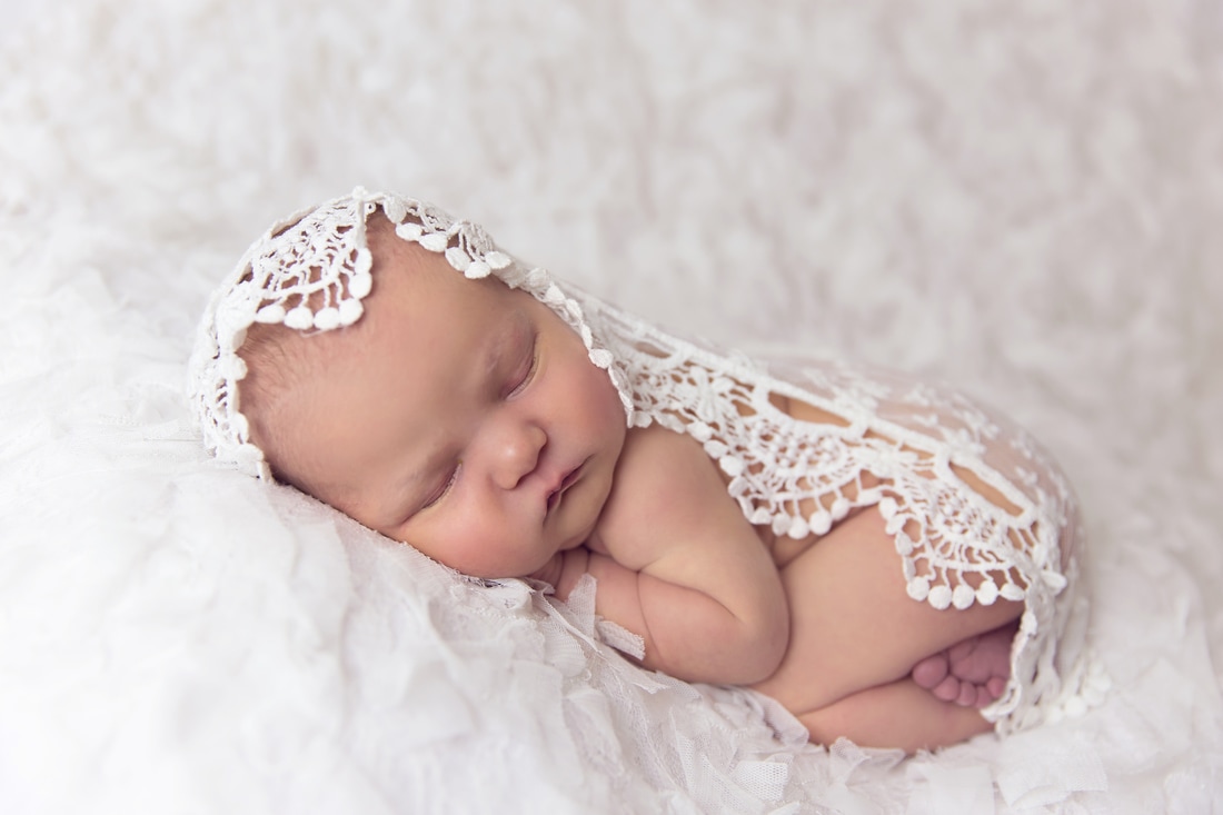 Tiny Feet Photography Newborn baby girl on white lace with white lace wrap