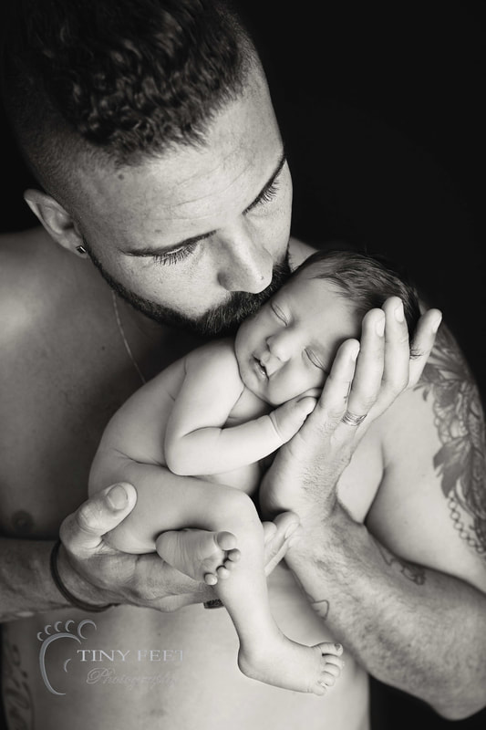 Tiny Feet Photography, newborn baby in black and white posed with dad