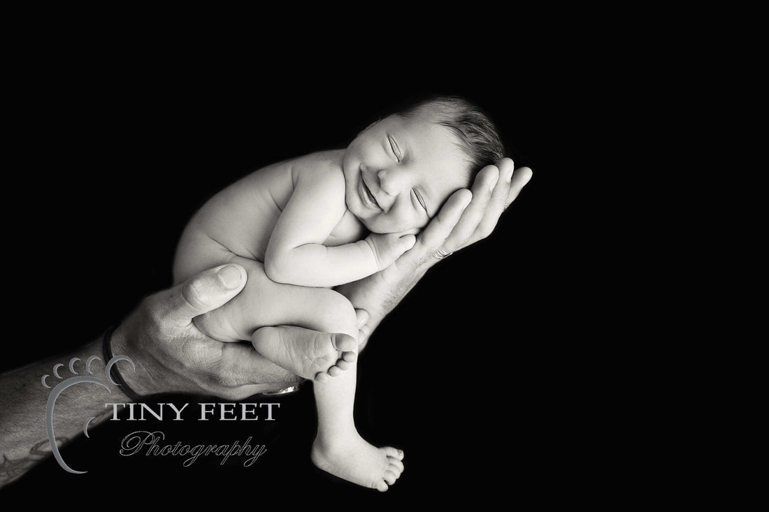 Tiny Feet Photography, newborn baby in black and white posed in dads hands
