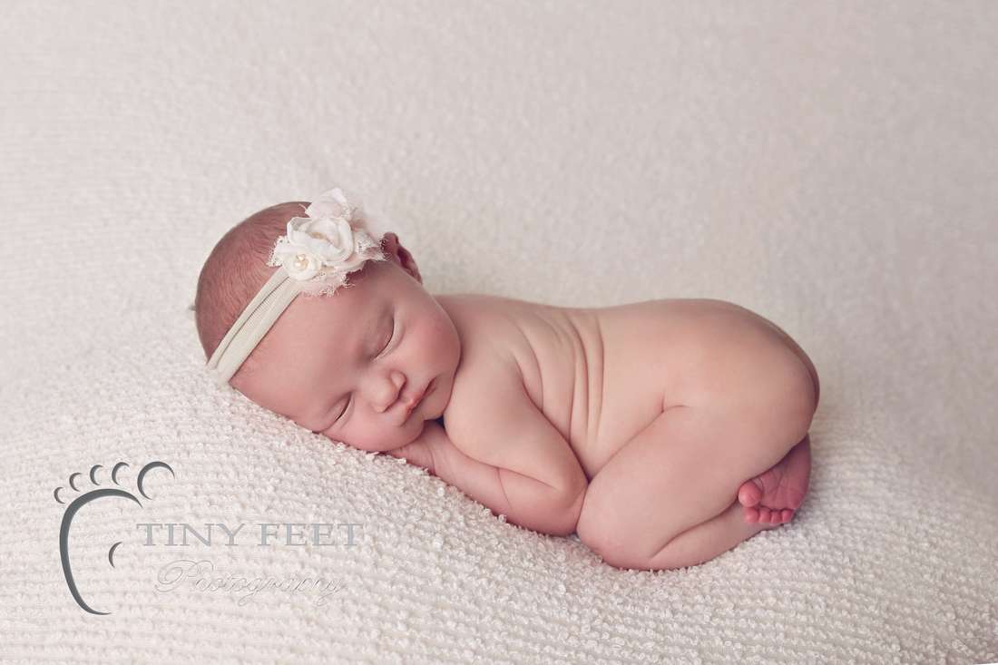 Tiny Feet Photography baby girl posed on beanbag in bum up pose 