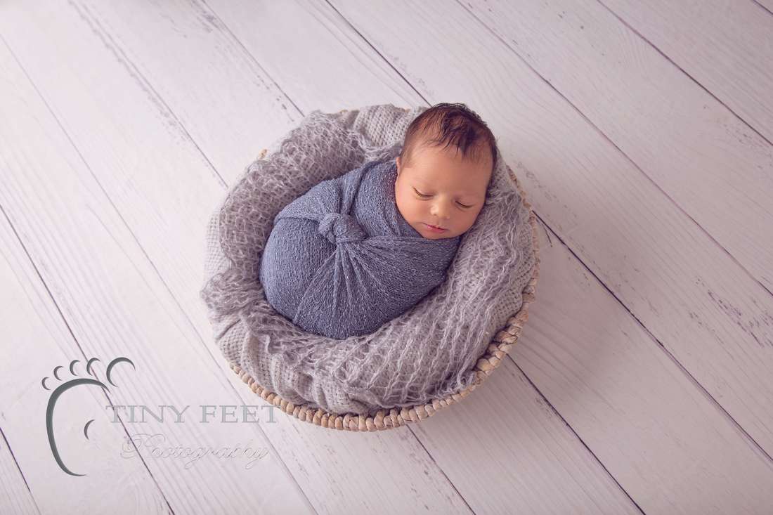 Tiny Feet Photography Newborn baby boy posed in grey wrap in bowl