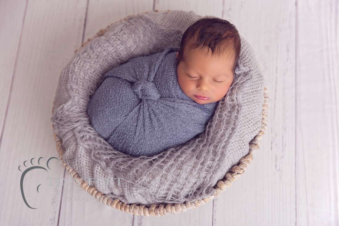 Tiny Feet Photography Newborn baby boy posed in grey wrap in bowl