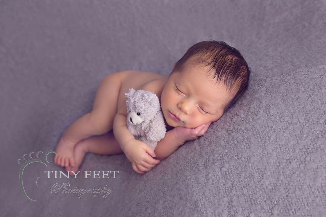 Tiny Feet Photography baby boy in side pose on grey blanket