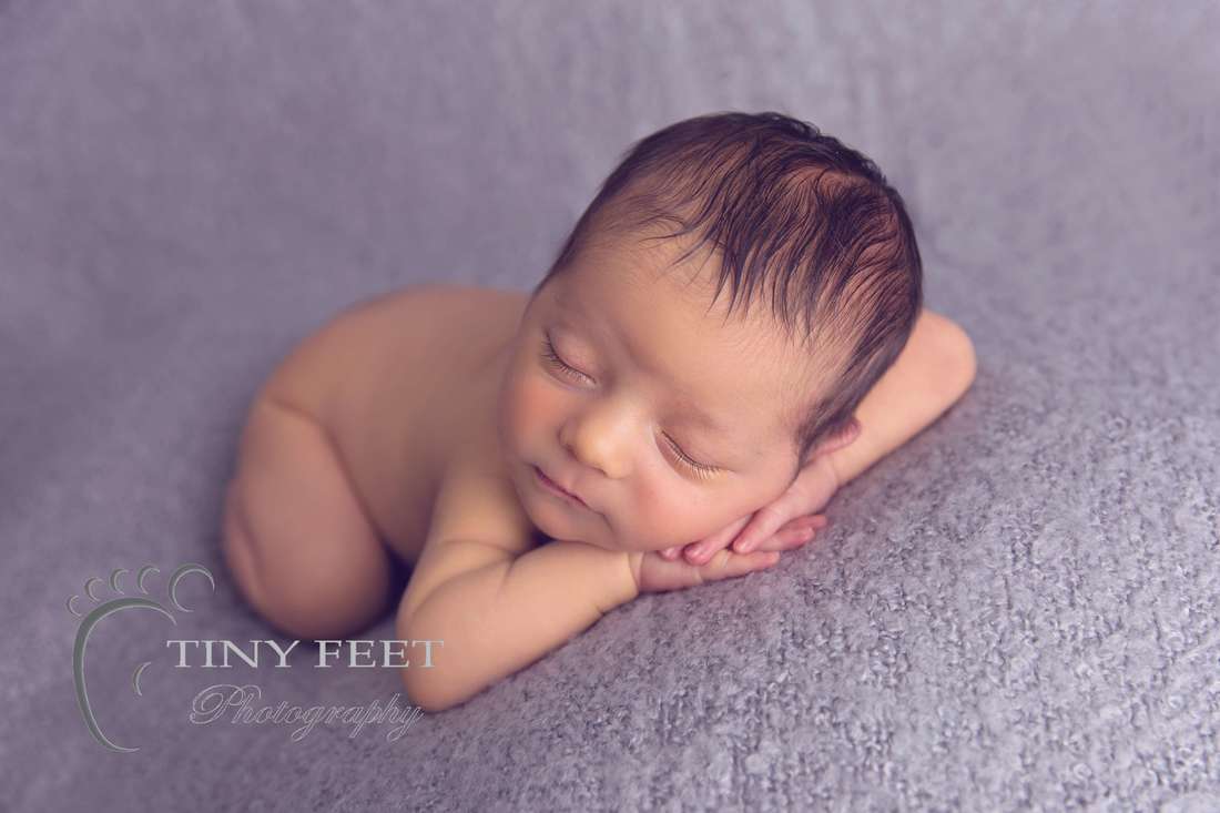 Tiny Feet Photography baby boy on chin on hands pose on grey blanket