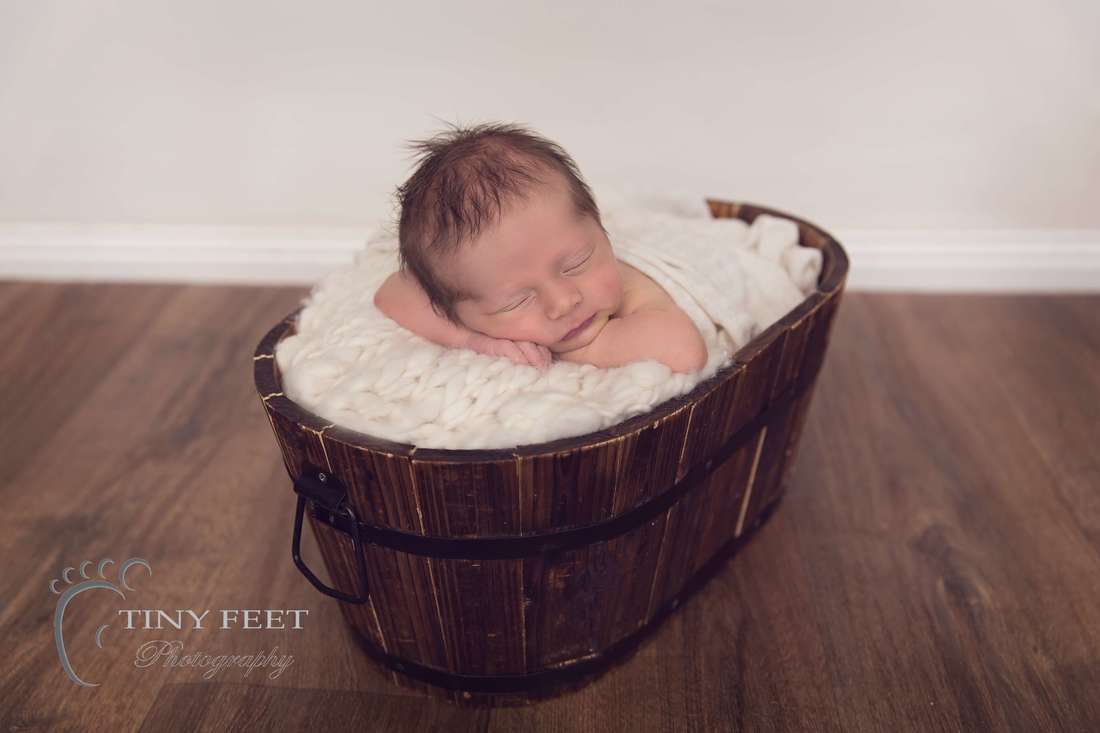 Tiny Feet Photography Newborn baby boy posed in brown bucket