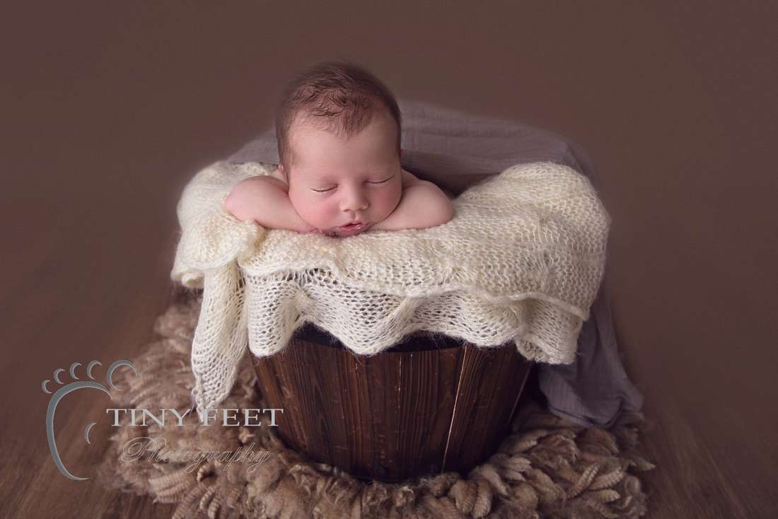 Tiny Feet Photography baby boy posed in chin on hands in bucket